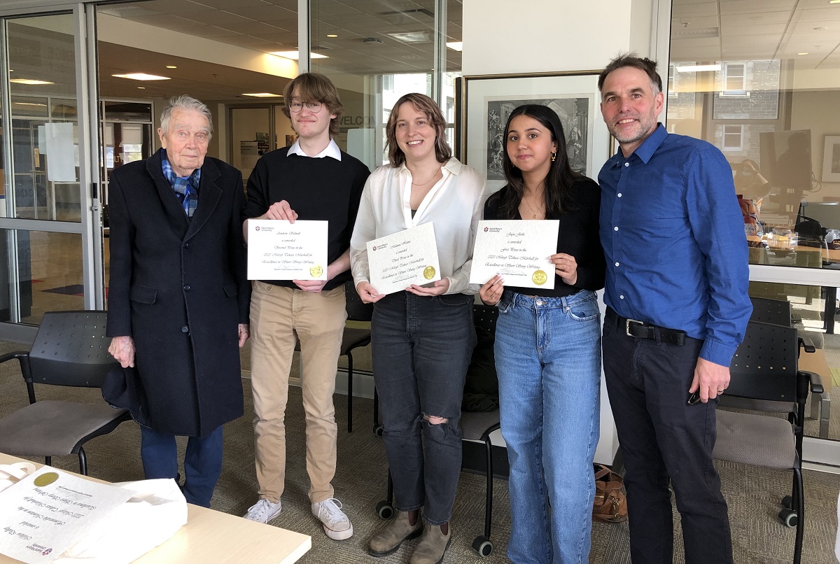 Dr. Rowland Marshall and 3 winners of 2023 writing prize standing with Dr. Alexander Macleod