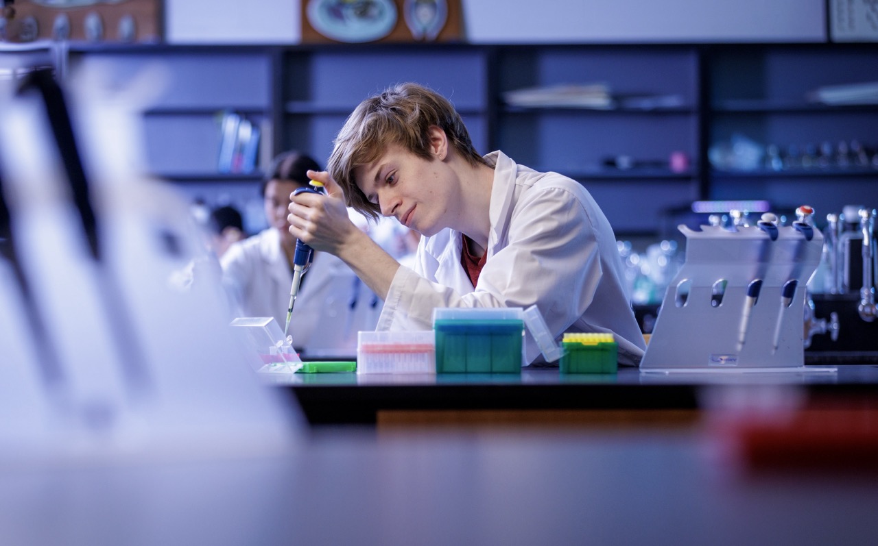 Student in biology lab using equipment