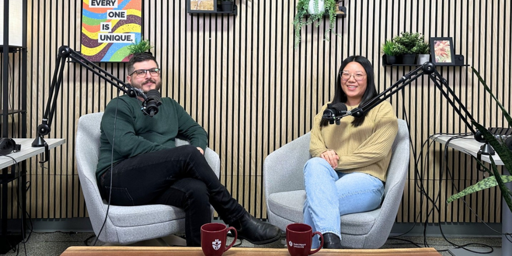 Professor and student sit together in the podcast studio