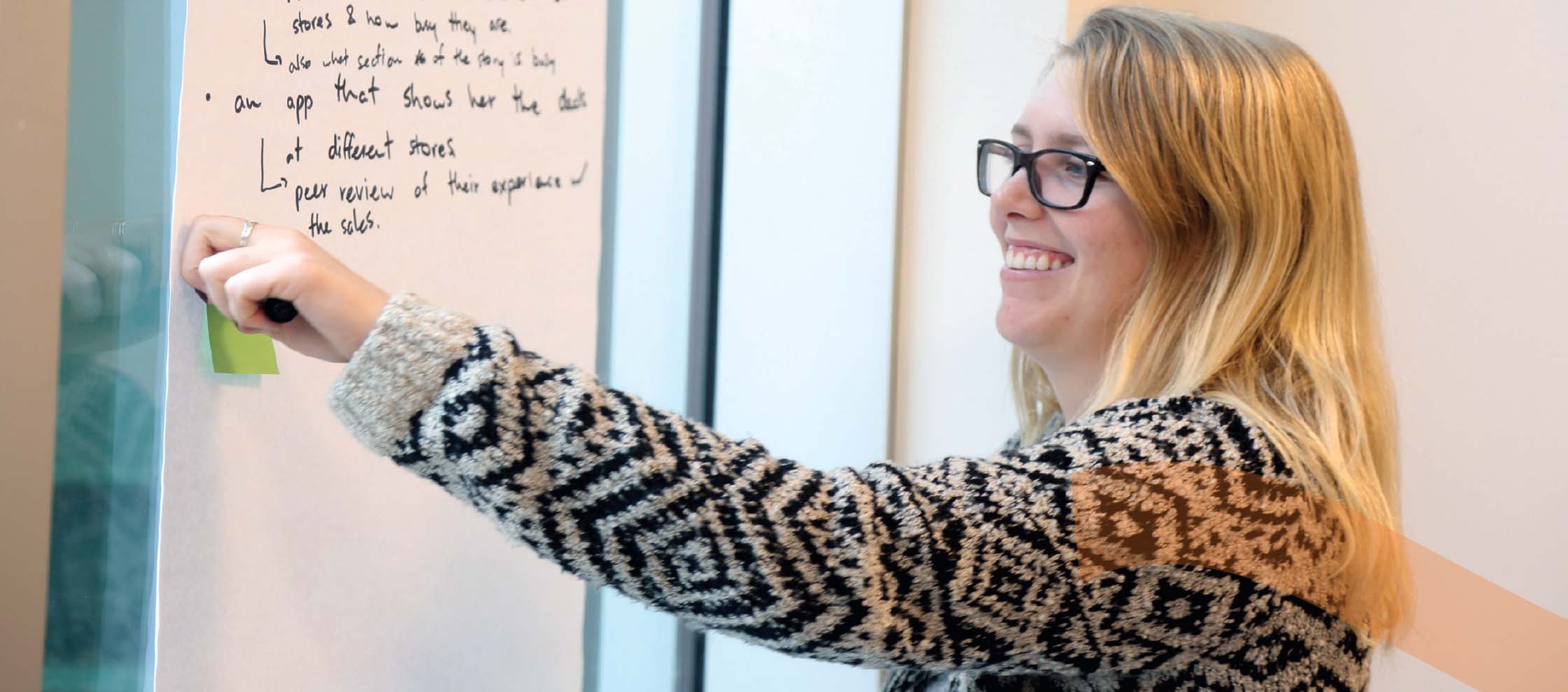 A woman writing on a whiteboard