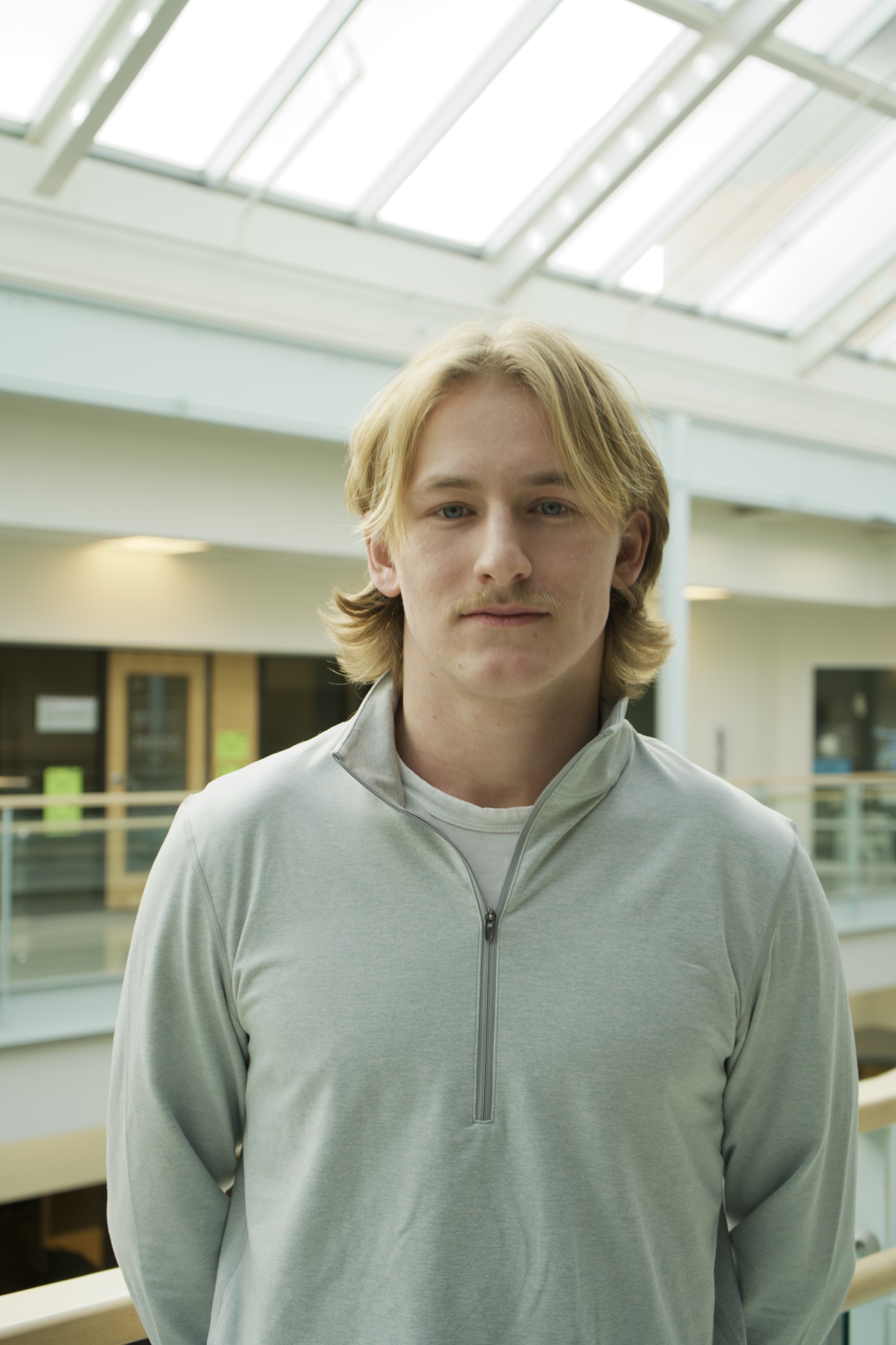 Griffin is a white man with blond hair. He wears a grey sweater.