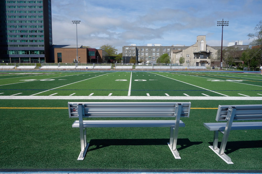Benches at Huskies Stadium looking oout over green turf