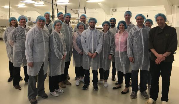 A group of Executive MBA students in protective clothing touring the Novo Nordisk facility in Denmark.