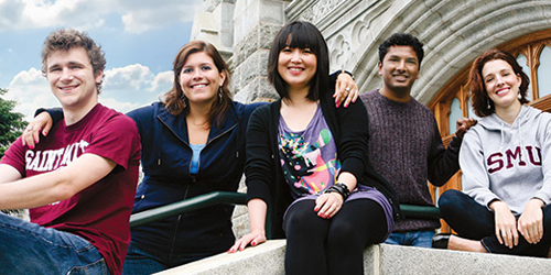 International Students sitting on steps on the McNally building