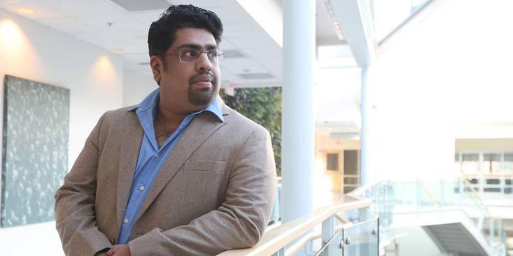 Dr. Jiju Poovvancheri looks out over the Atrium
