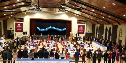 Members of the Saint Mary's community form a circle at the Indigenous Gala event.