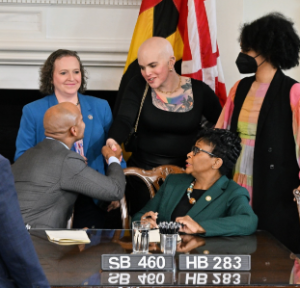 Margo Quinlan shaking the hand of a man in a suit