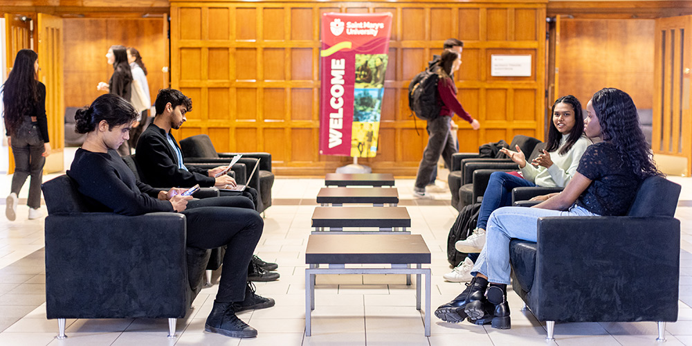 Students sitting in the lobby inside the McNally Main building