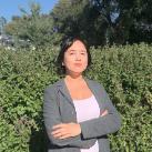 Woman standing in front of bush