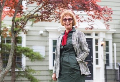 Dr. Evangelia Tastsoglou standing in front a tree.